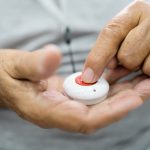 Man Pressing Alarm Button For Emergency