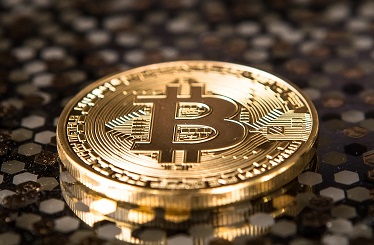 gold-colored Bitcoin coin on ground